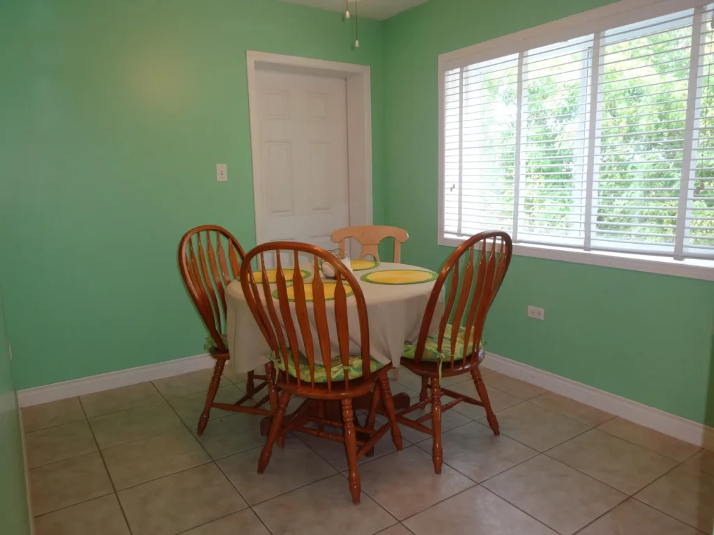 Dining area beside a large window at Sunset Paradise 1